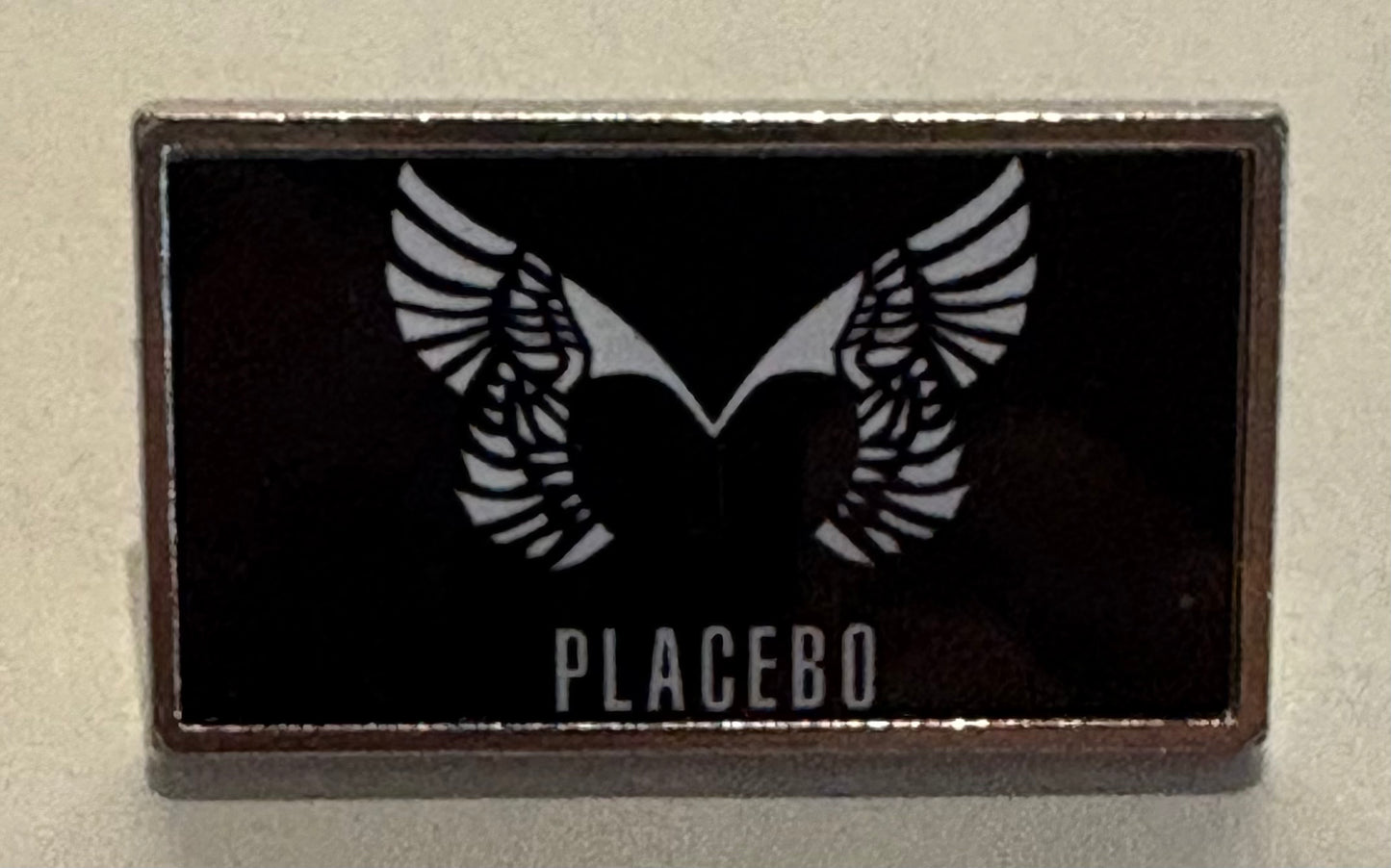 Placebo pin badge