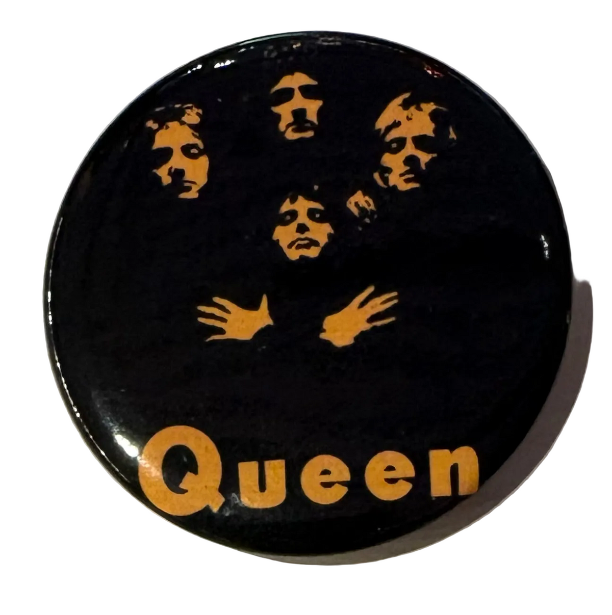 Queen Black and Orange faces pin badge